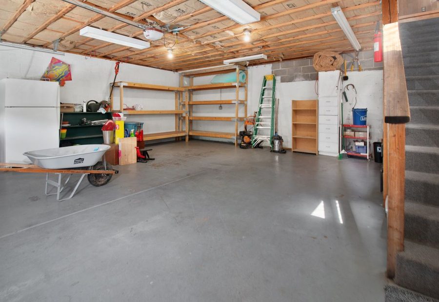Poured garage floor slab with thickened edges over a vapor barrier
